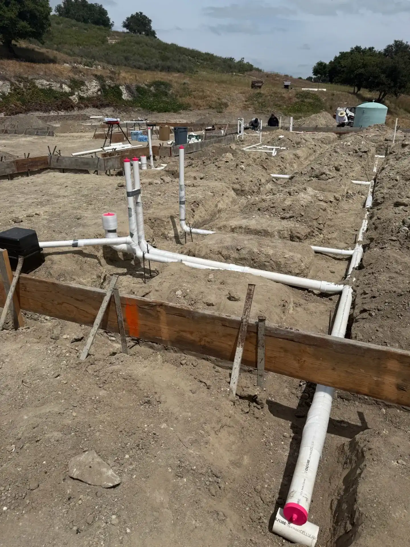 Ground-up underground PVC rough-in on a Central Coast new construction site